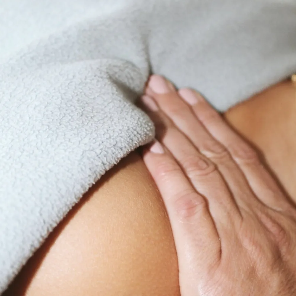 Hand massaging a back